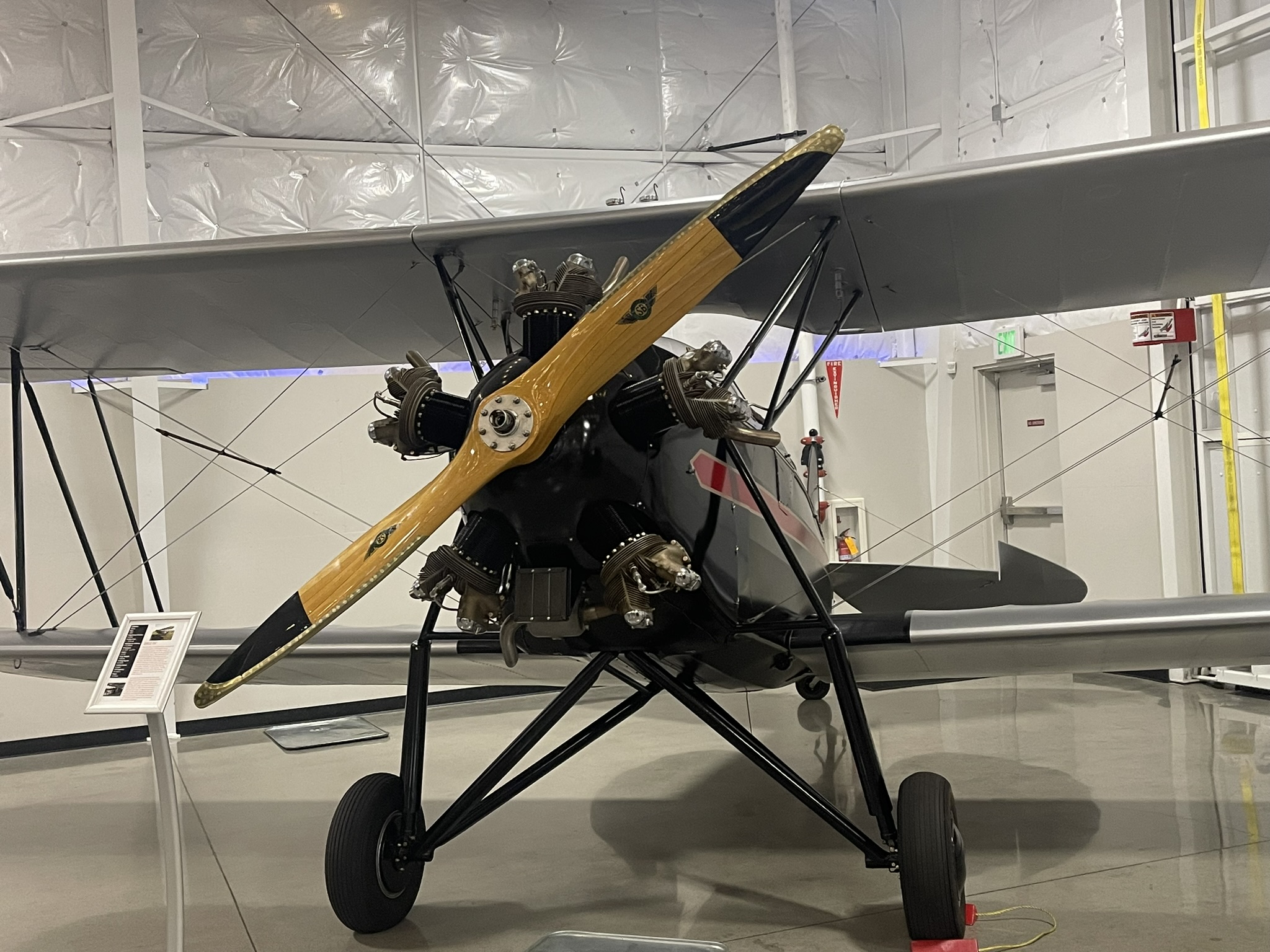 a propeller plane that is hanging on a wall