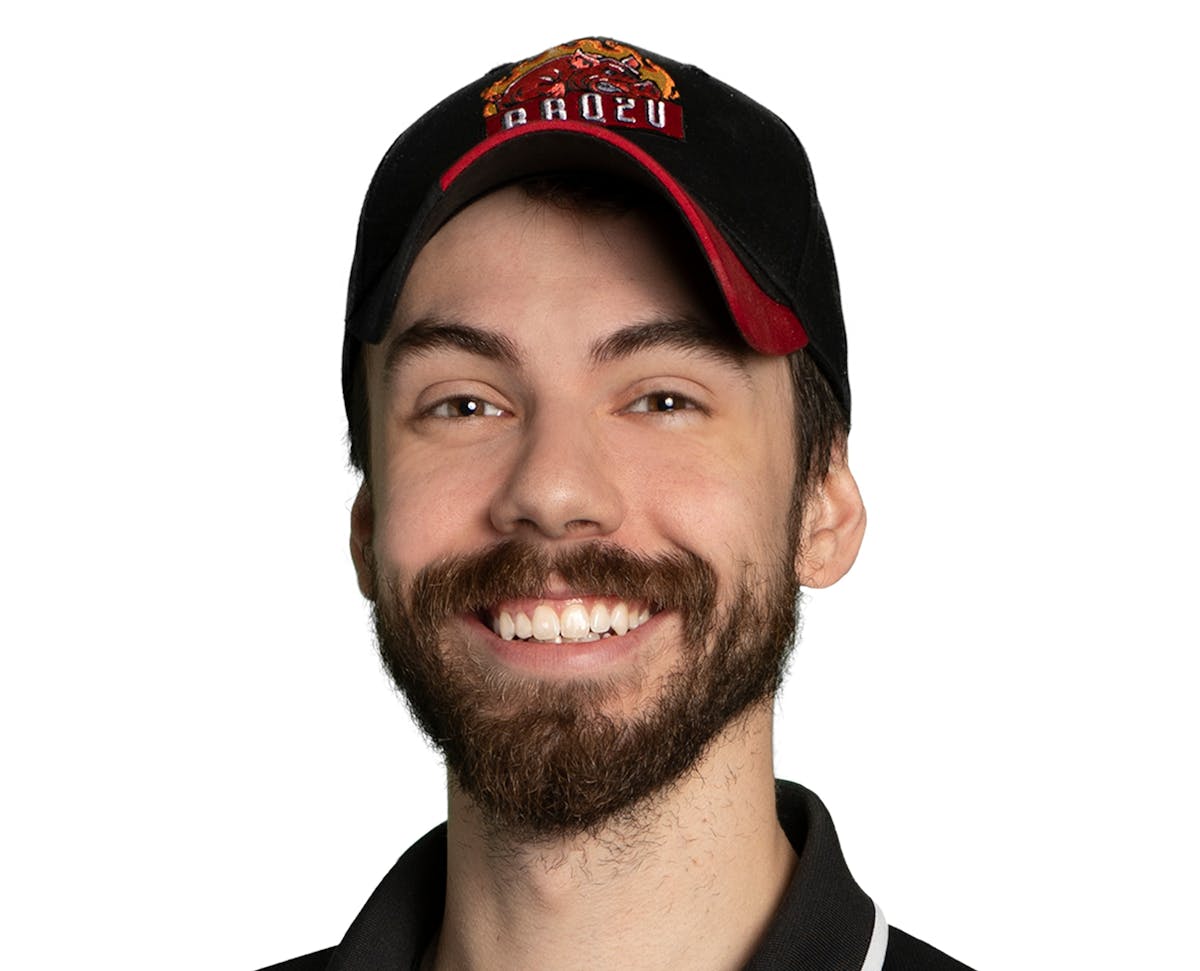 a man wearing glasses and smiling at the camera