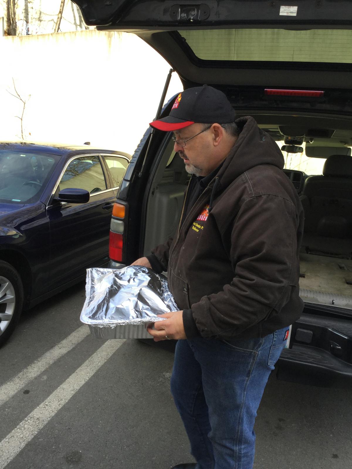 a man standing in front of a car