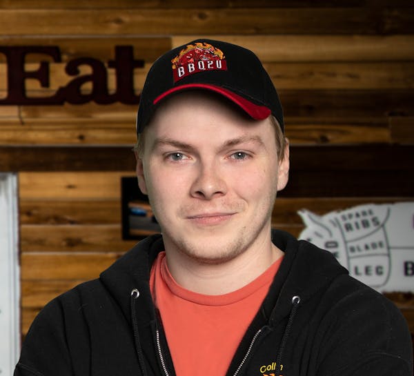a person wearing a hat and smiling at the camera
