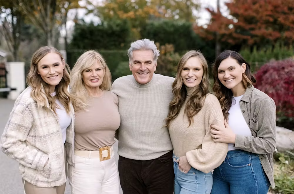 a person holding a hot dog on a grill