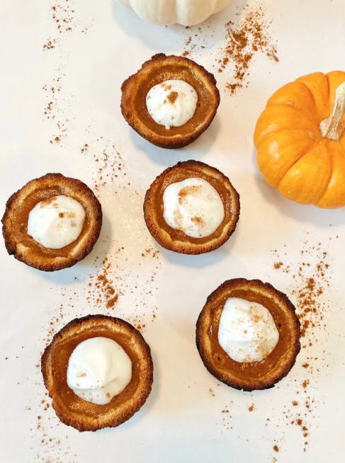 5 mini pumpkin pies next to to mini pumpkins