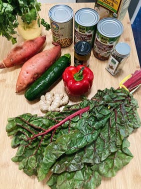 a wooden table topped with lots of fresh vegetables