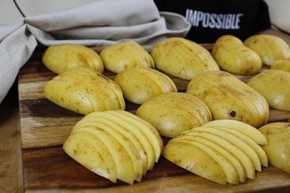 a banana sitting on top of a wooden cutting board