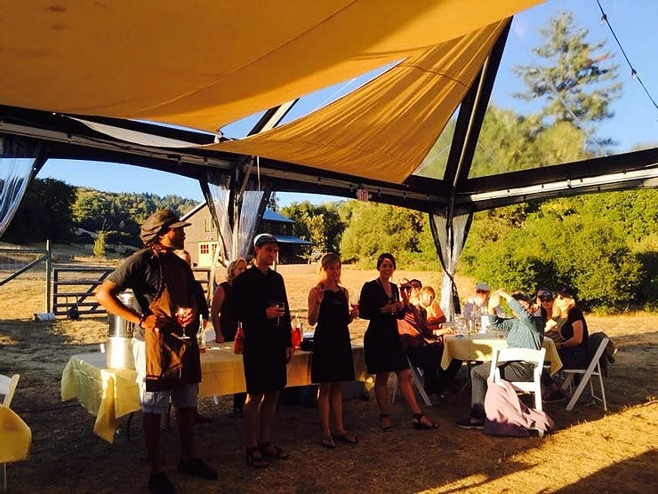 a group of people standing in front of a tent