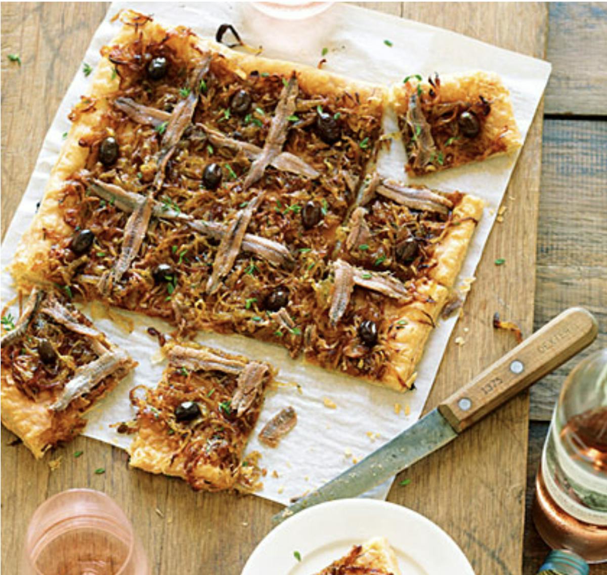 a slice of pizza sitting on top of a wooden cutting board