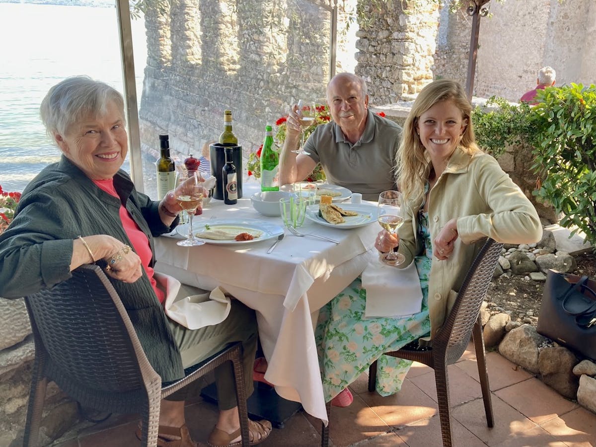 a group of people sitting at a table eating food