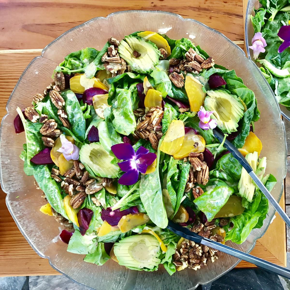 a salad sitting on top of a wooden table