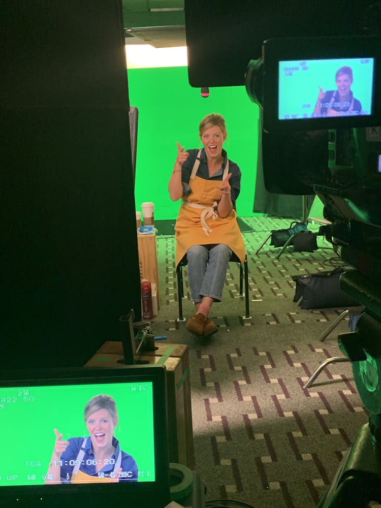 Chef Anja Lee smiling in front of a green screen