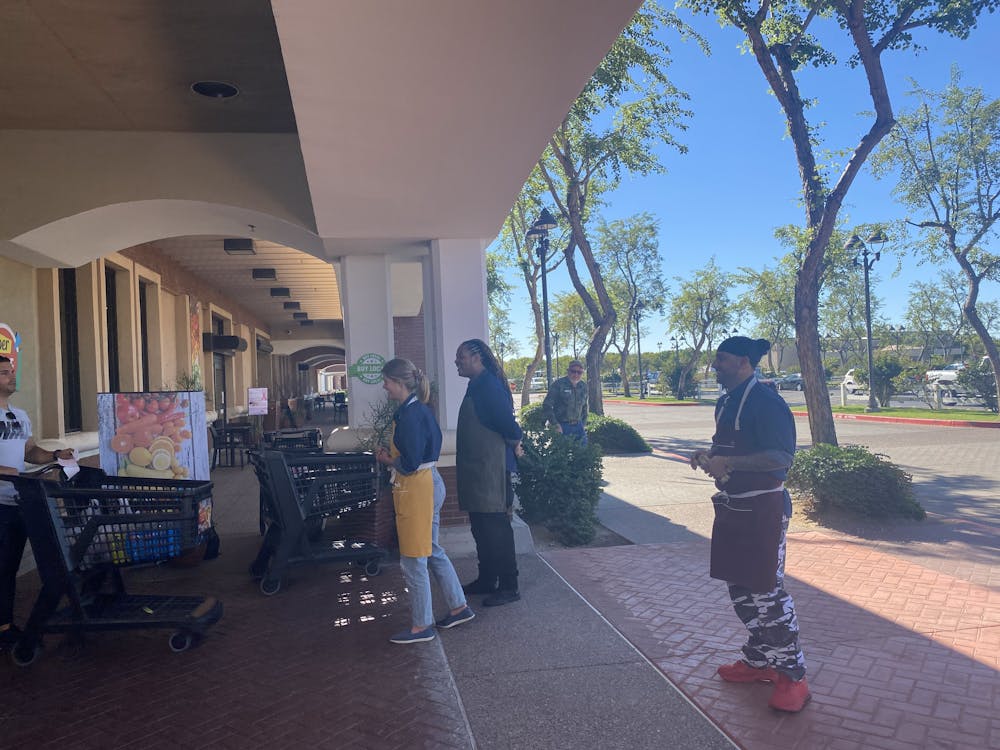 3 people standing in front of a super market