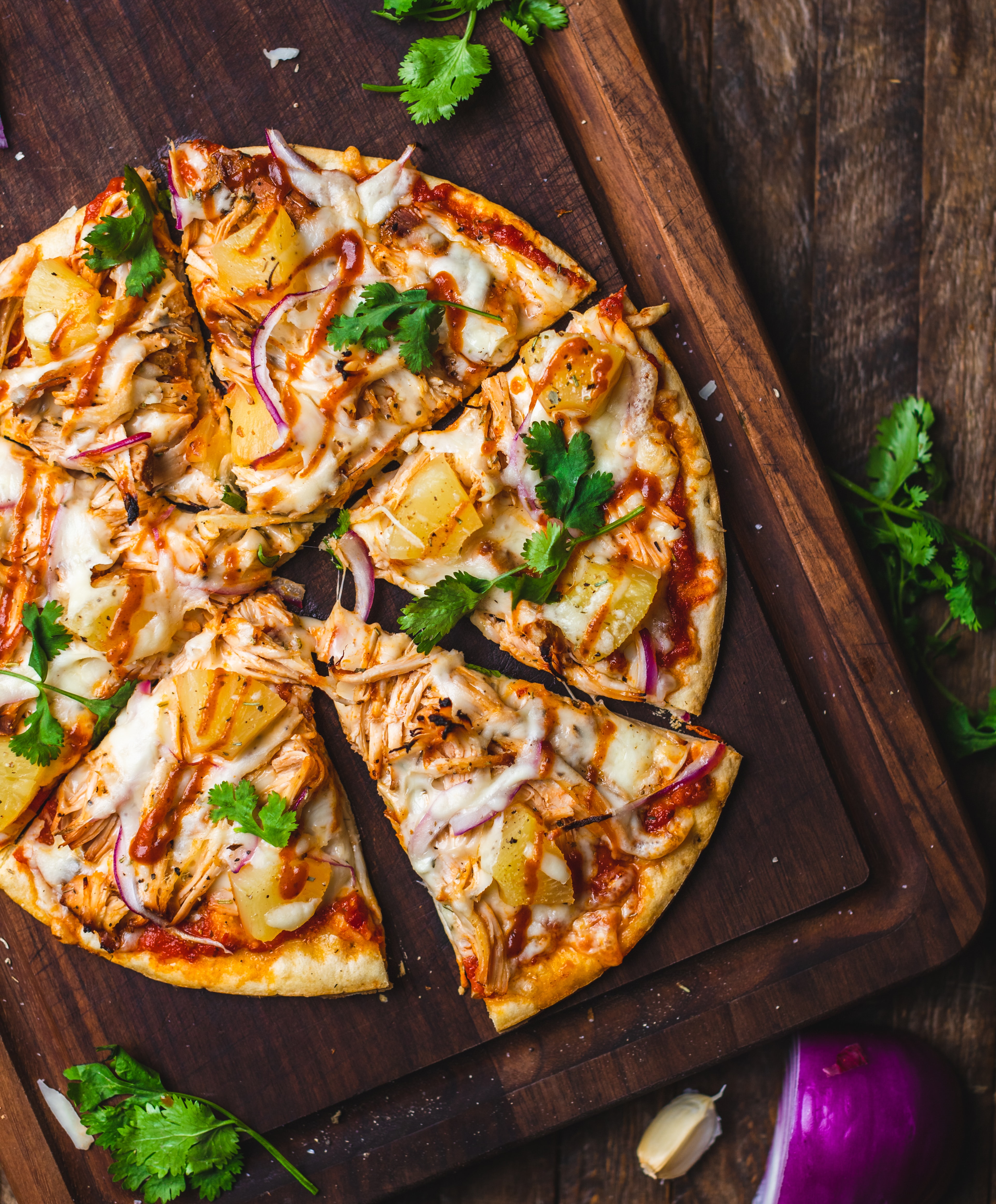 a pizza sitting on top of a wooden cutting board