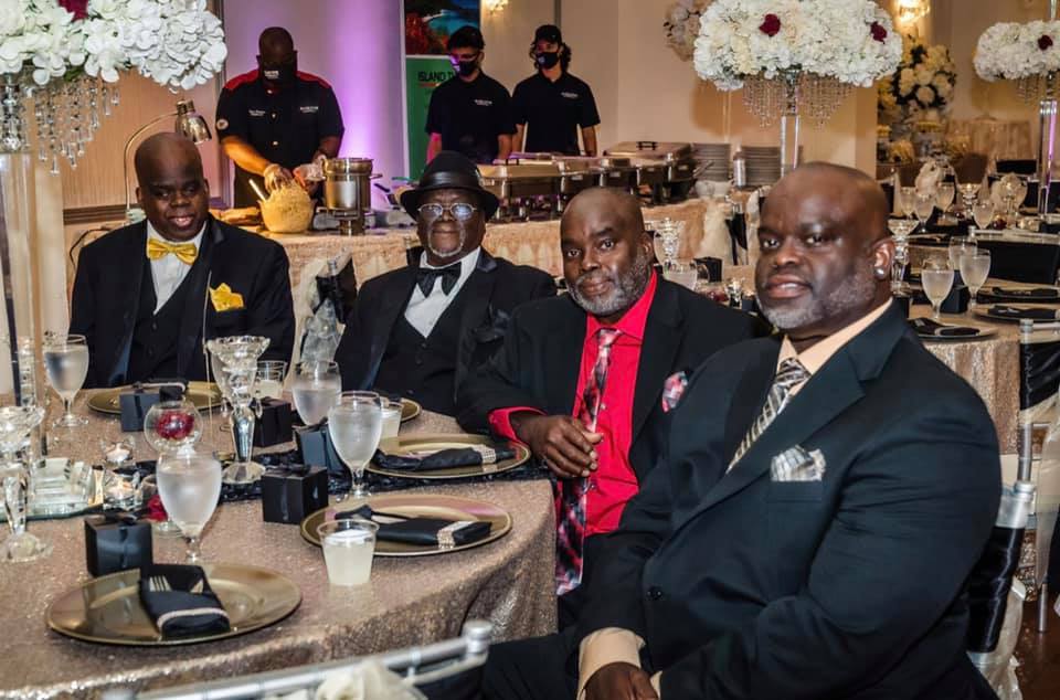people sitting at a table posing for a photo