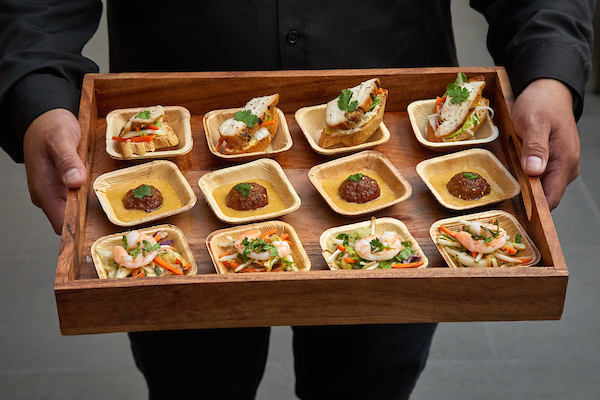 a person holding a tray of food