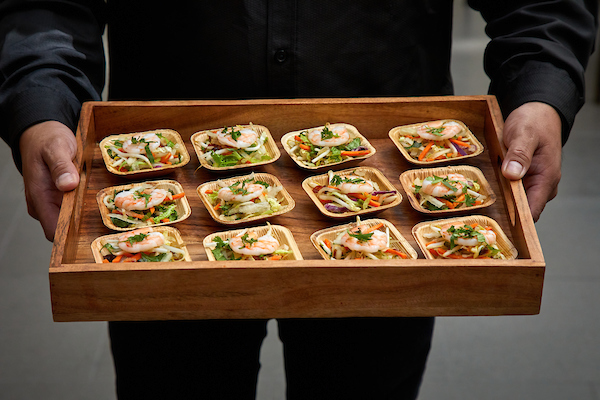a person holding a tray of food