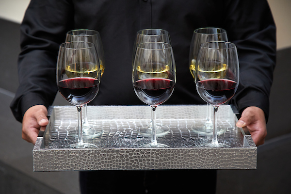 a tray with glass of wine