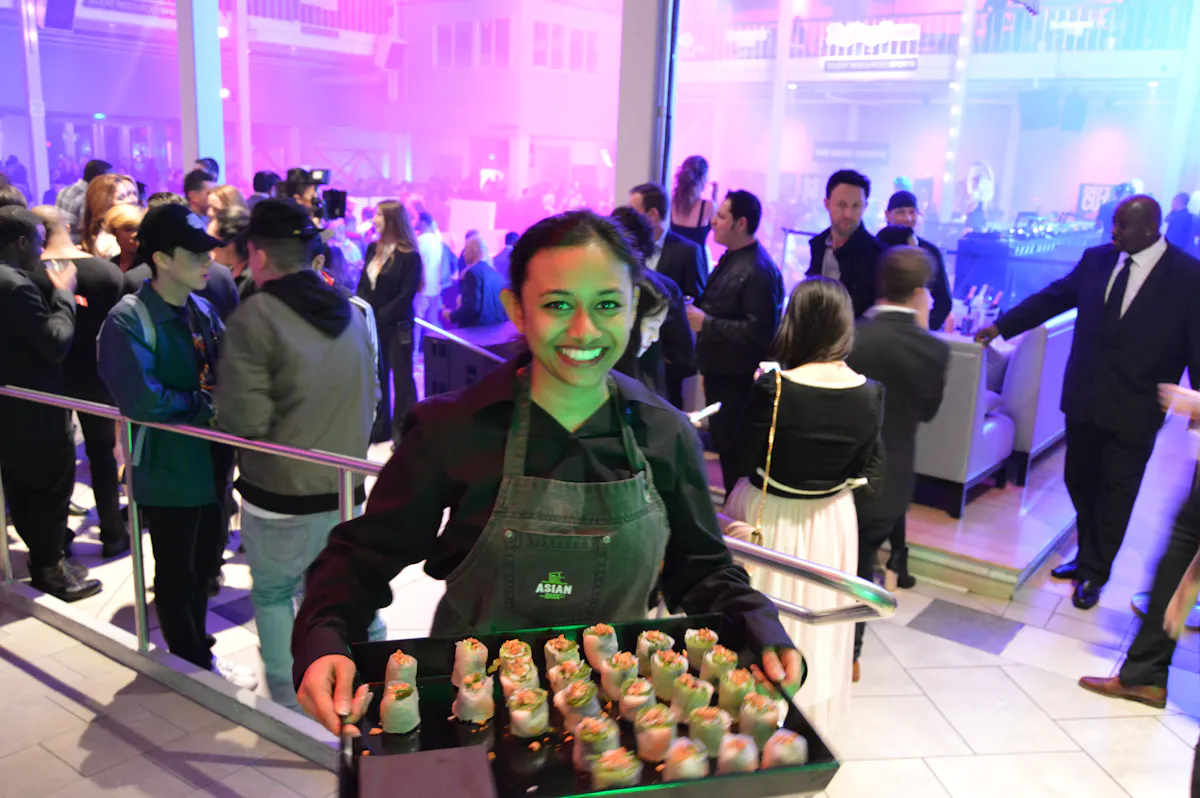 a person holding a tray of food