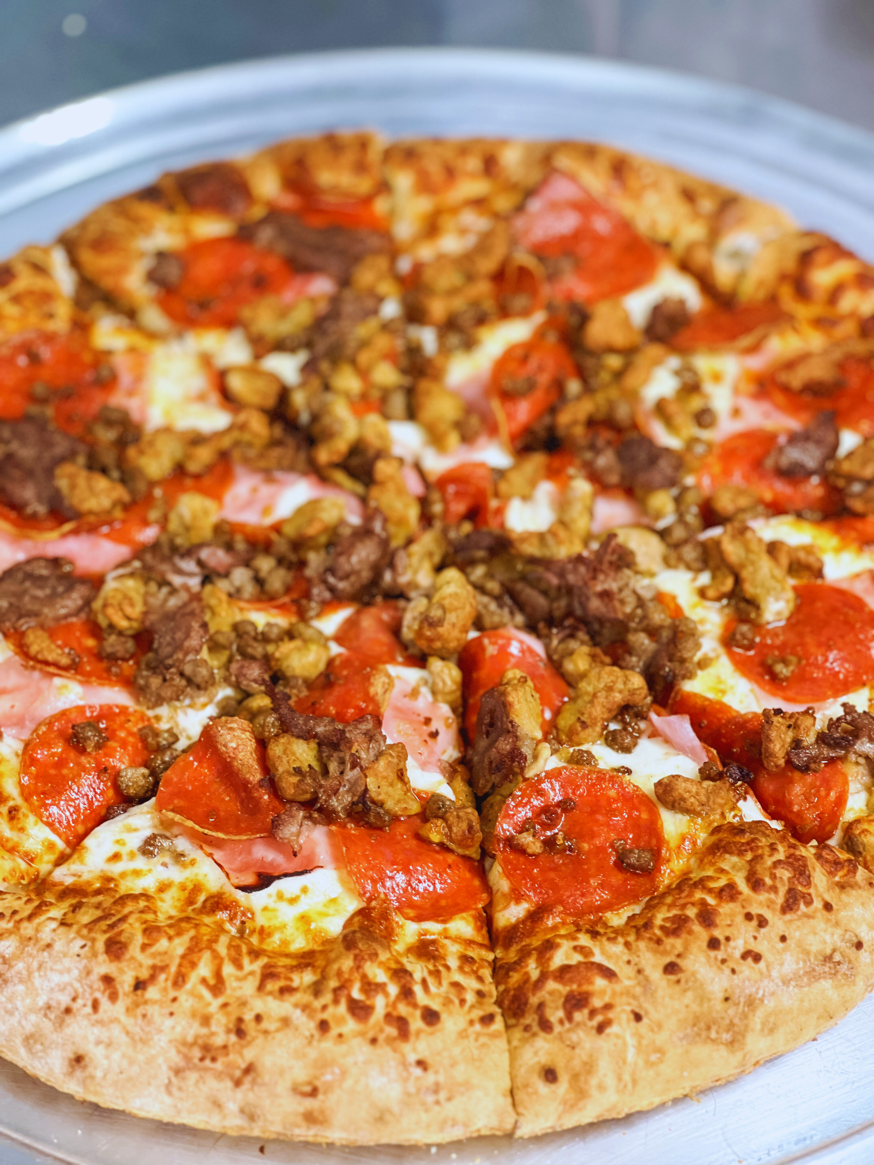 a pizza sitting on top of a plate of food