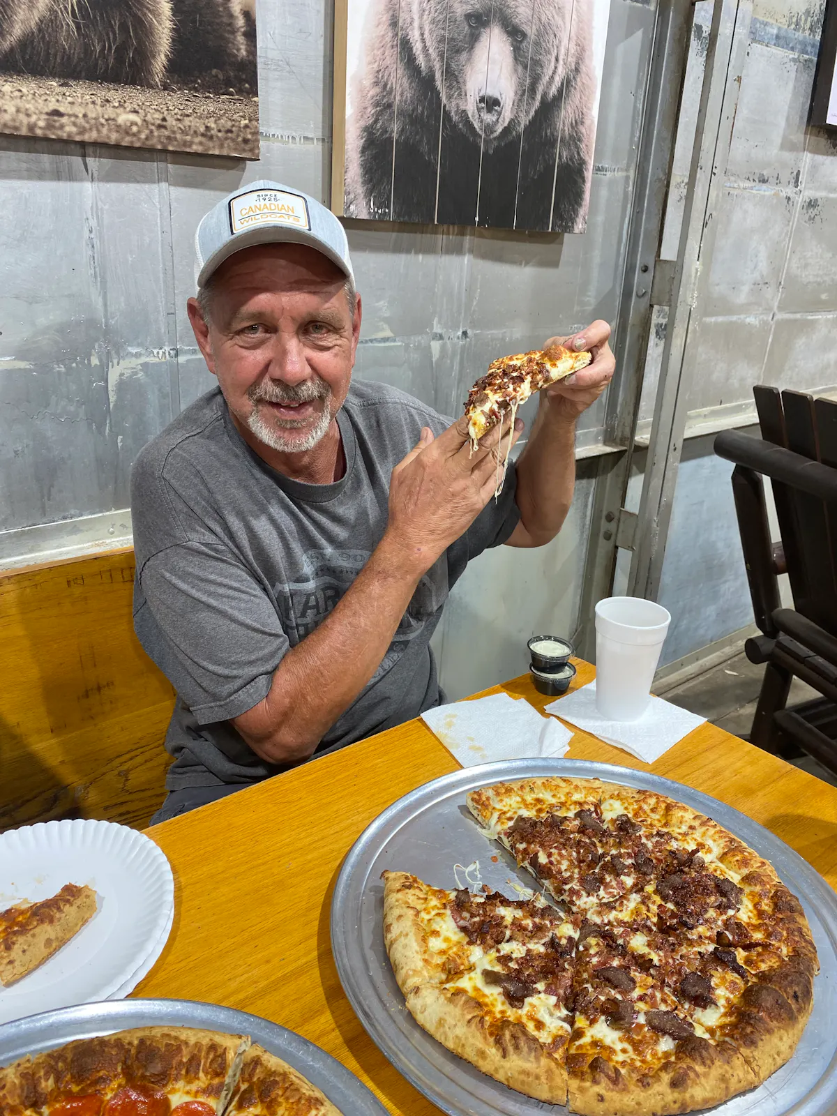 a man sitting at a table with a plate of food