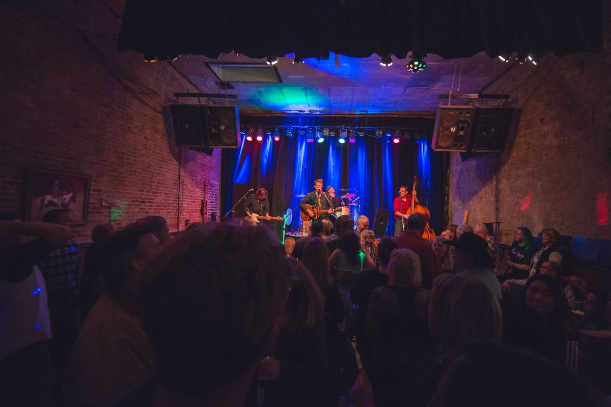 a group of people standing on a stage in front of a crowd