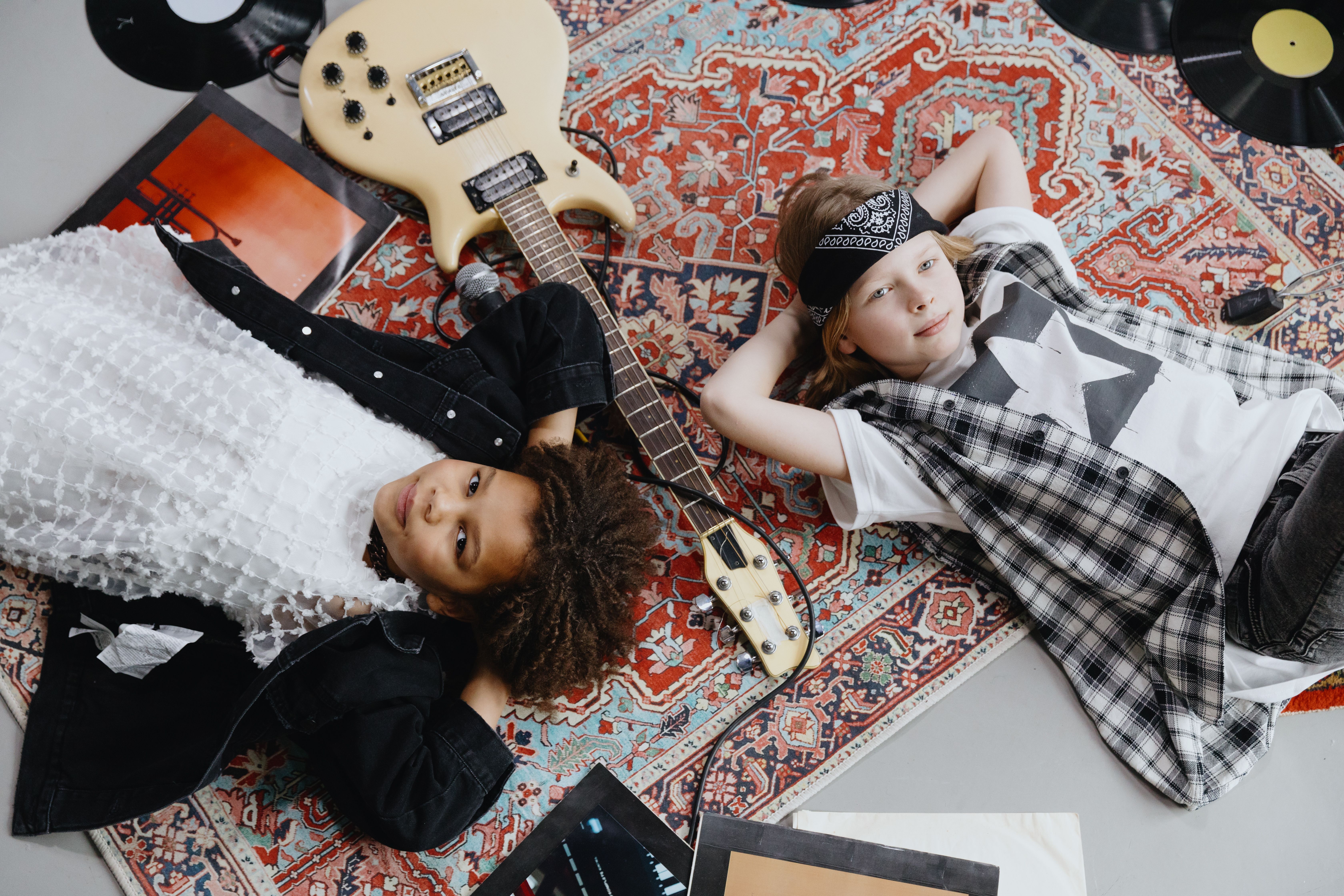 two kids on the floor with guitars
