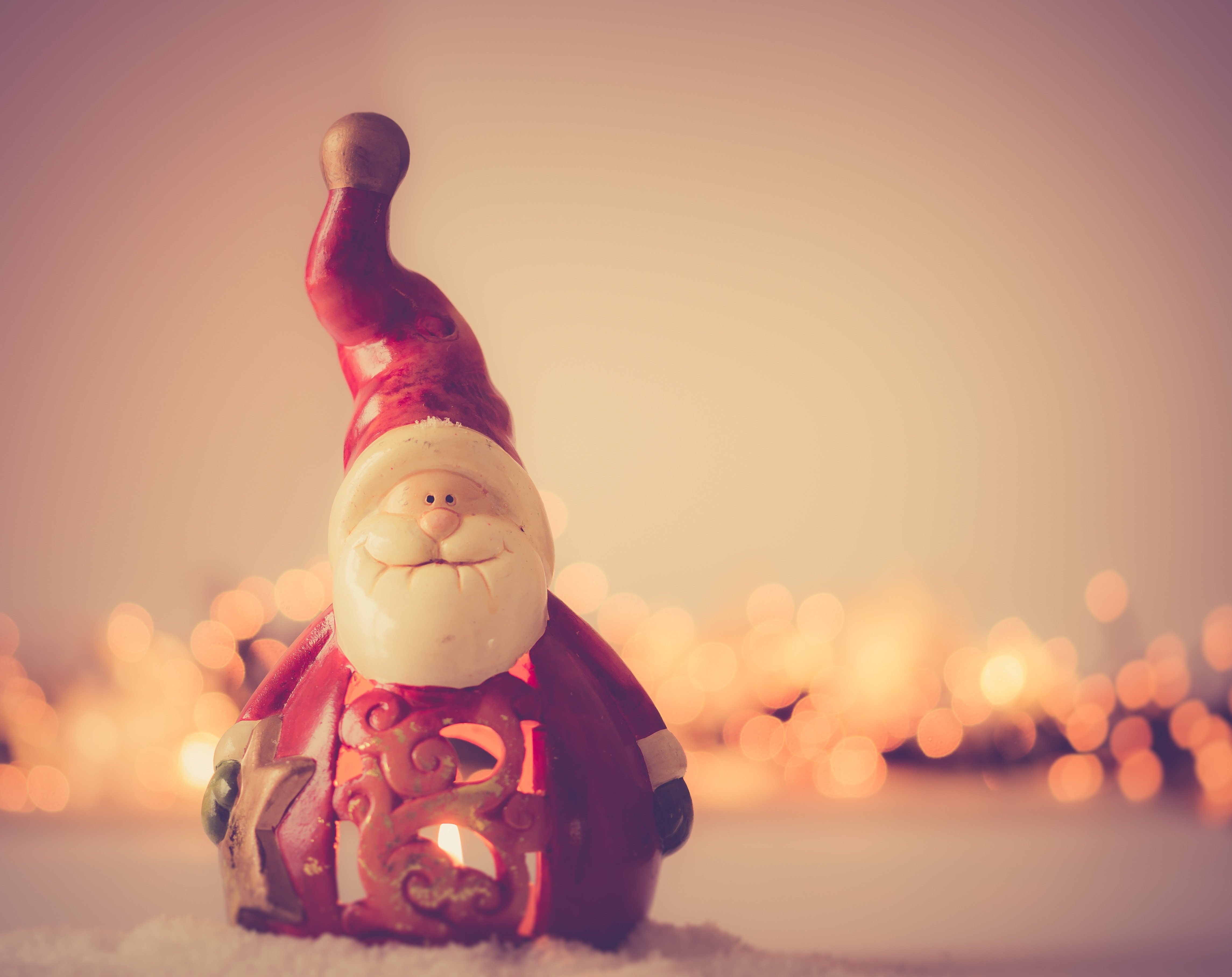 Santa Claus figurine staring at us with candles in the back. Post reads Merry Christmas