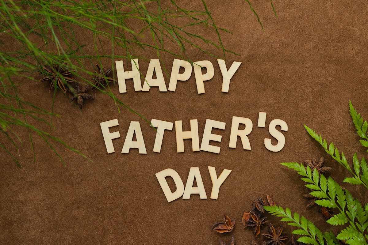 Happy Fathers Day message. Wood and twigs and some green.