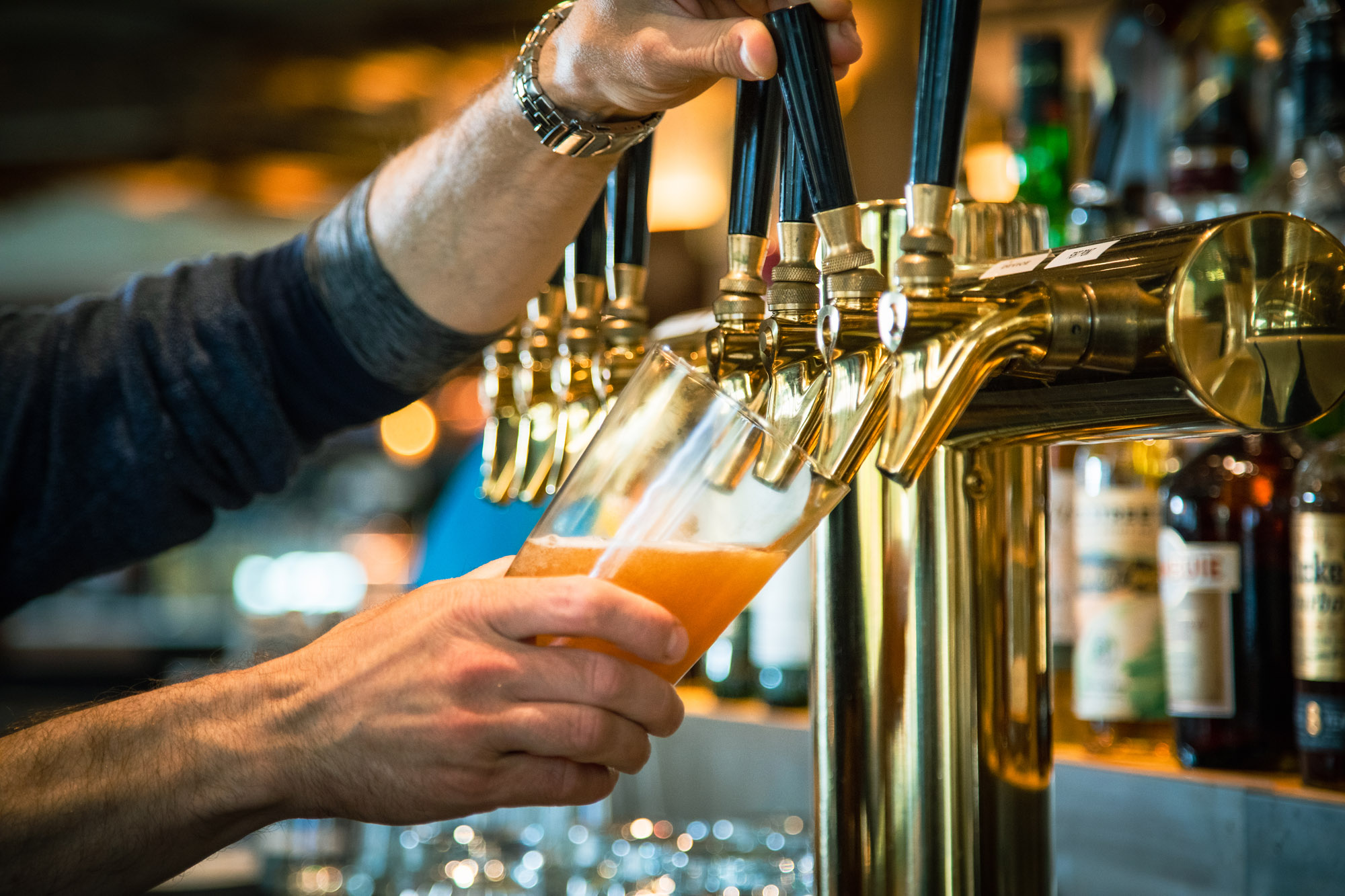 a hand holding a bottle of wine