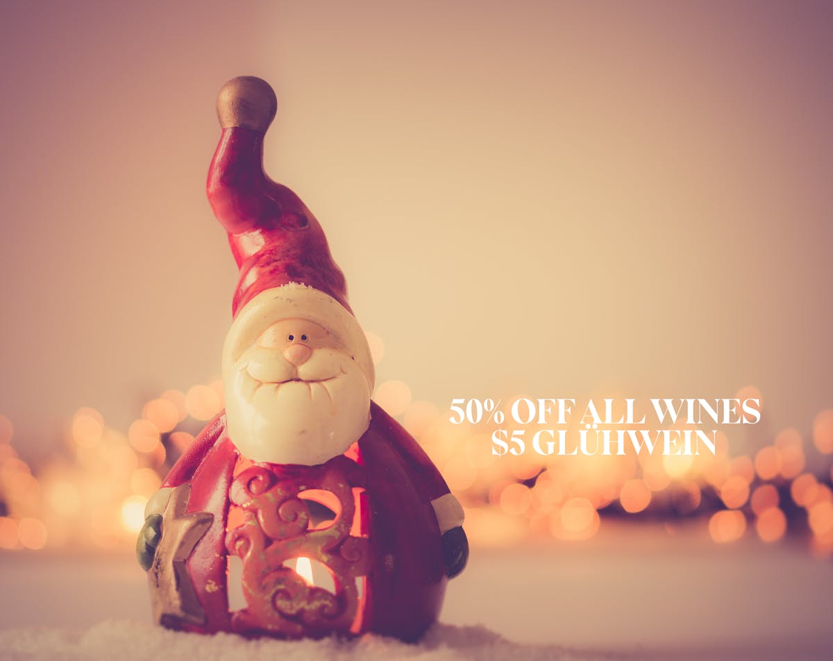 Santa Claus figurine staring at us with candles in the back. Post reads Merry Christmas