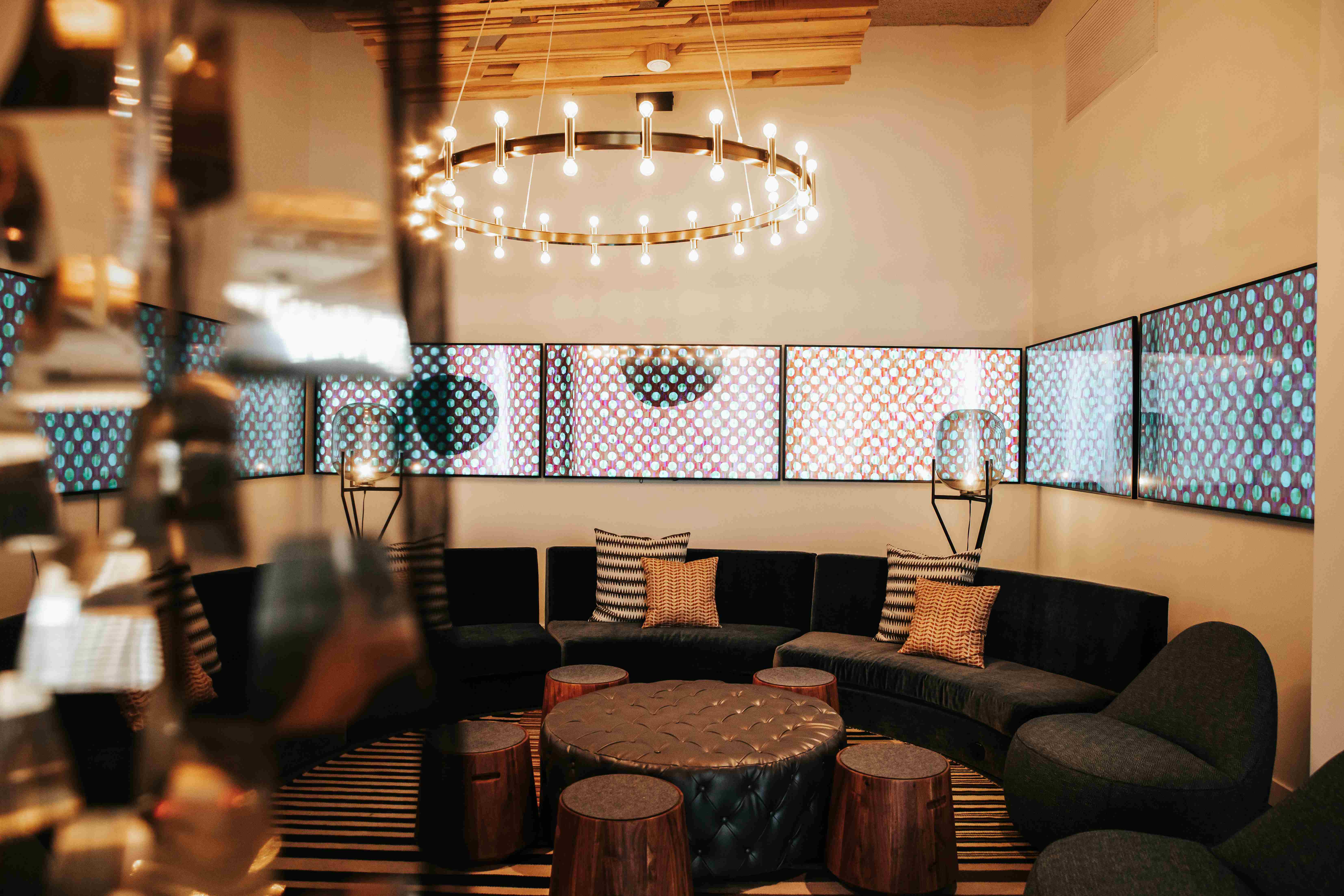 a comfortable area with chairs arranged in a circular pattern around a table and chandellier