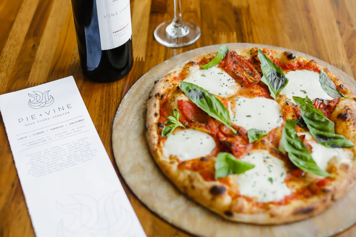 a pizza sitting on top of a wooden table