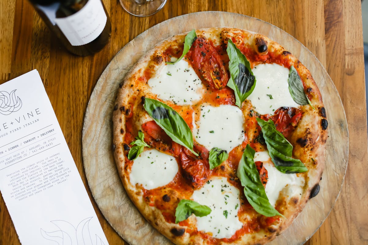 a pizza sitting on top of a wooden table