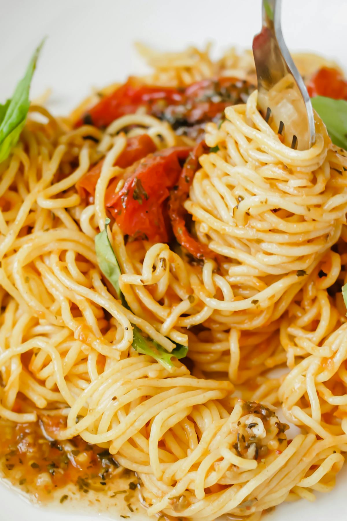 a close up of pasta in a white dish