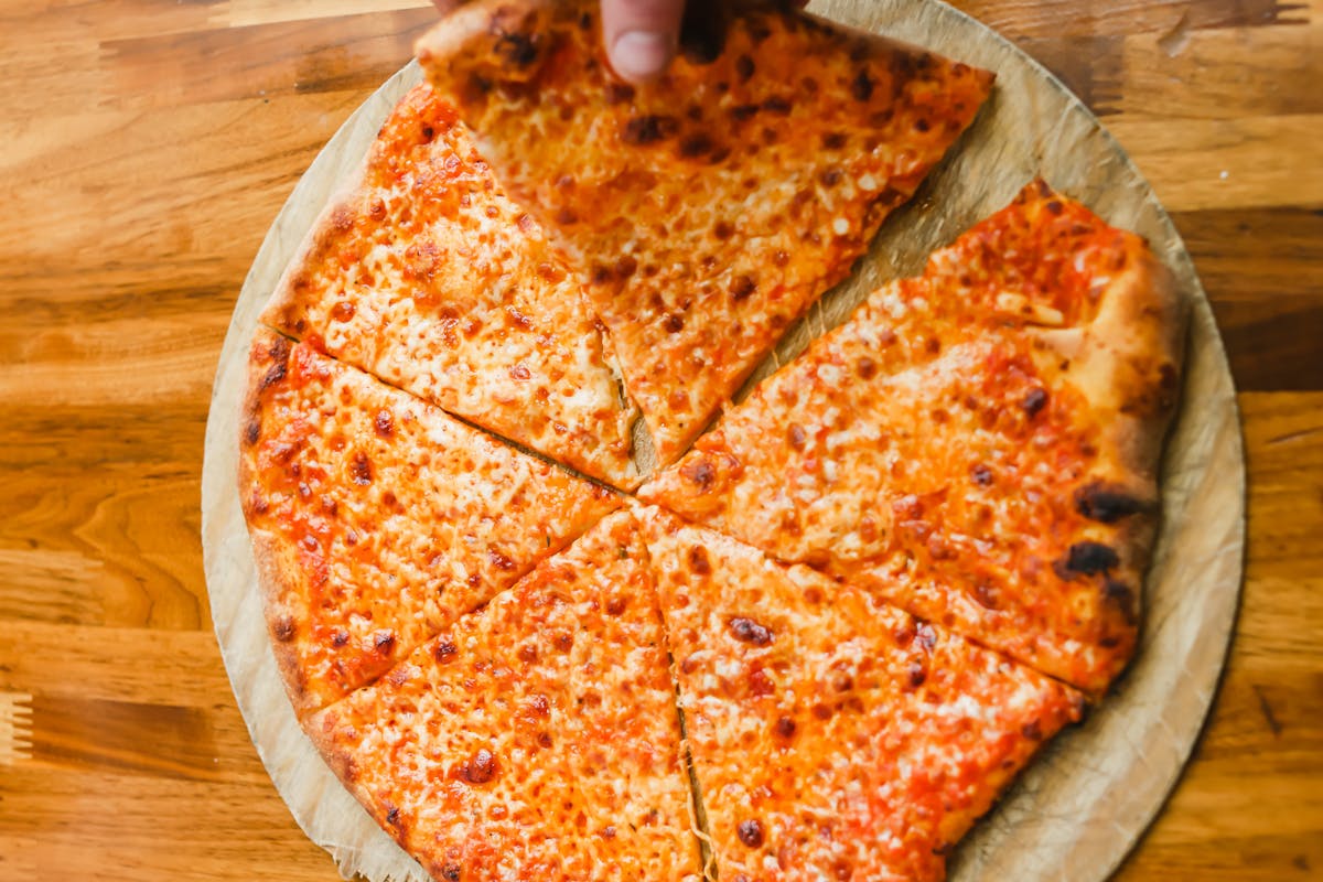 A pizza sitting on top of a wooden cutting board