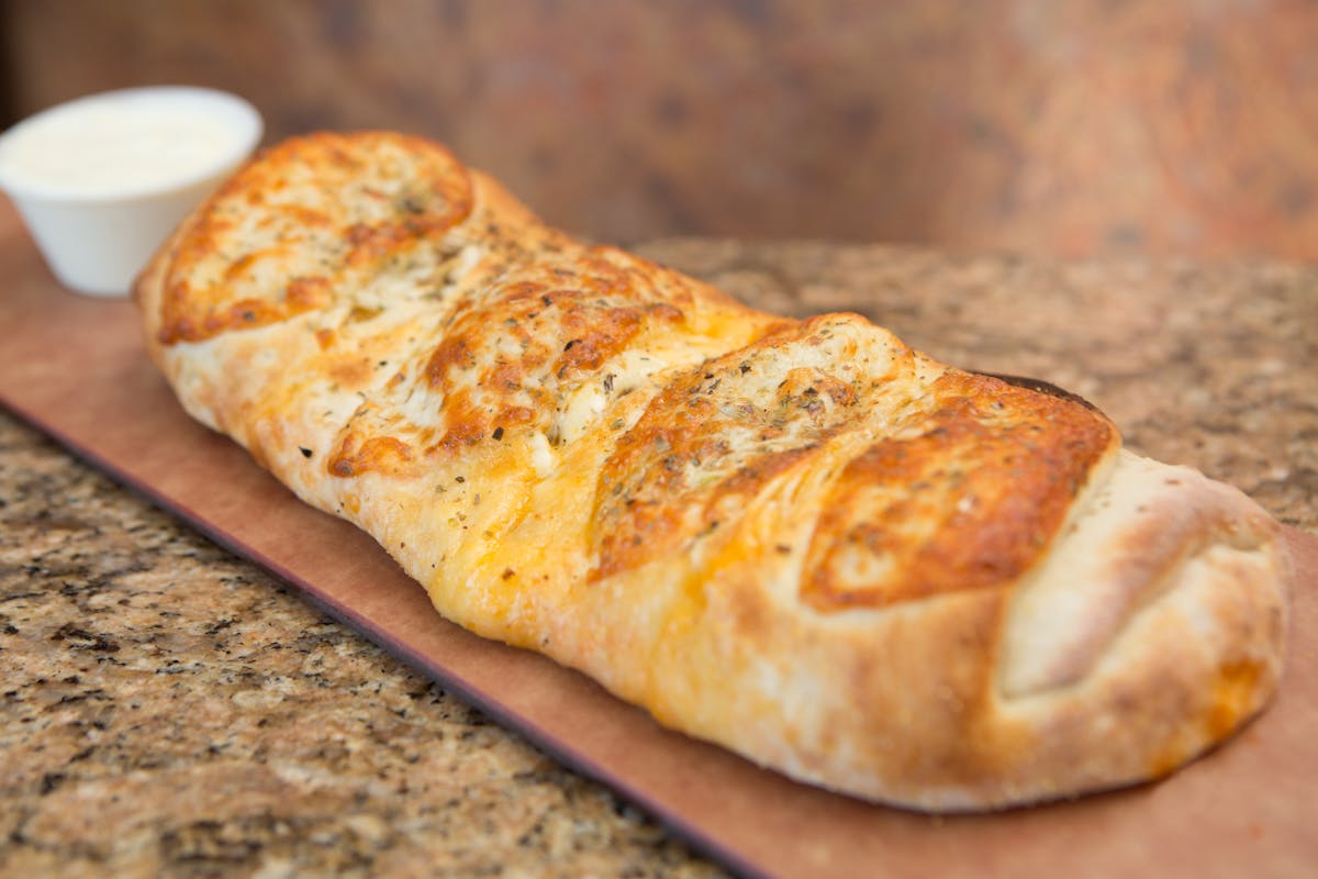 a slice of pizza sitting on top of a wooden cutting board