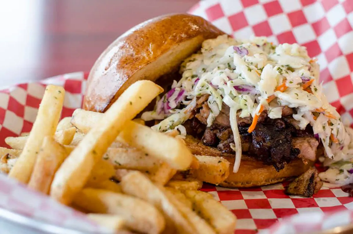 a close up of a sandwich and fries on a plate