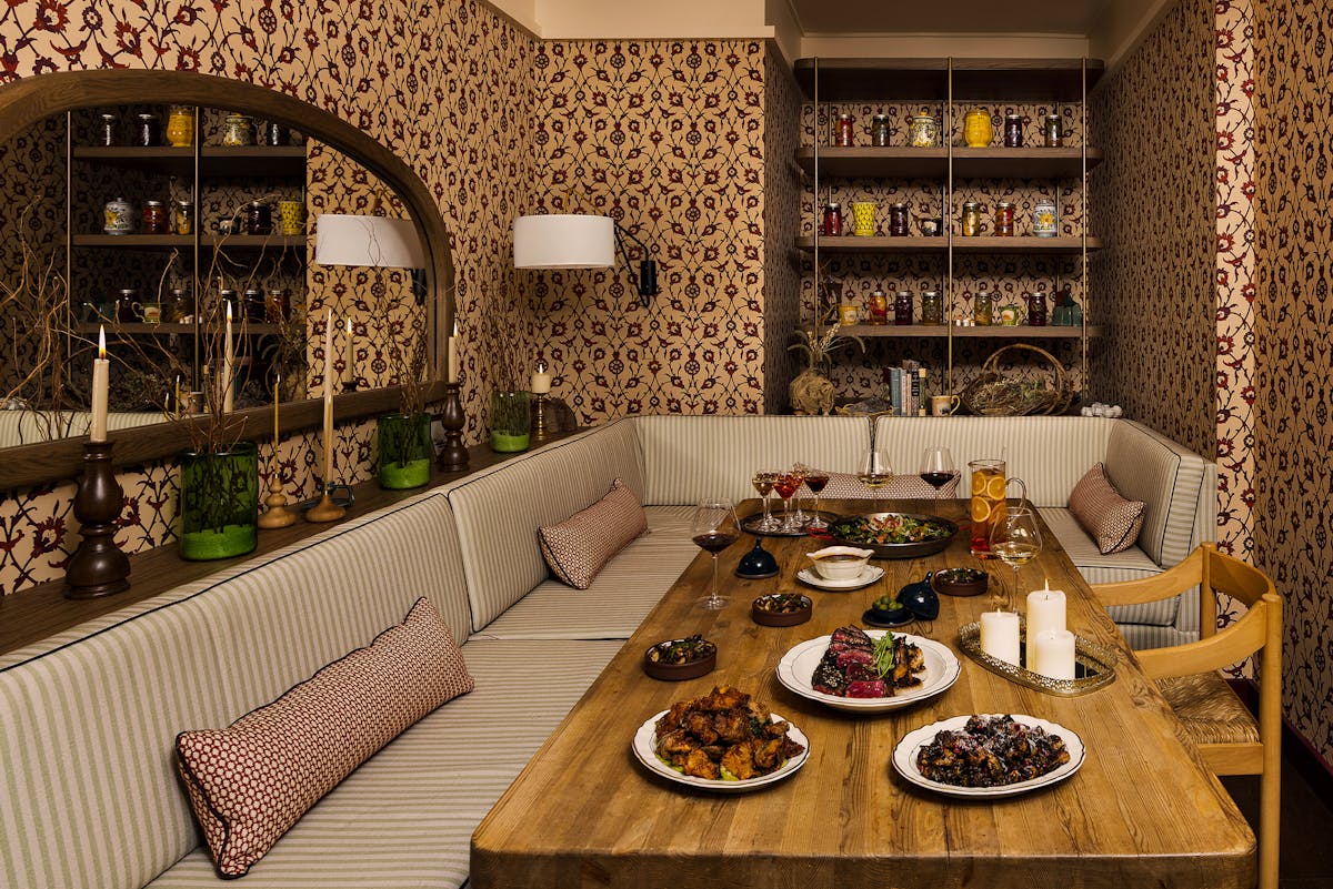 a room with a couch and a table in front of a mirror