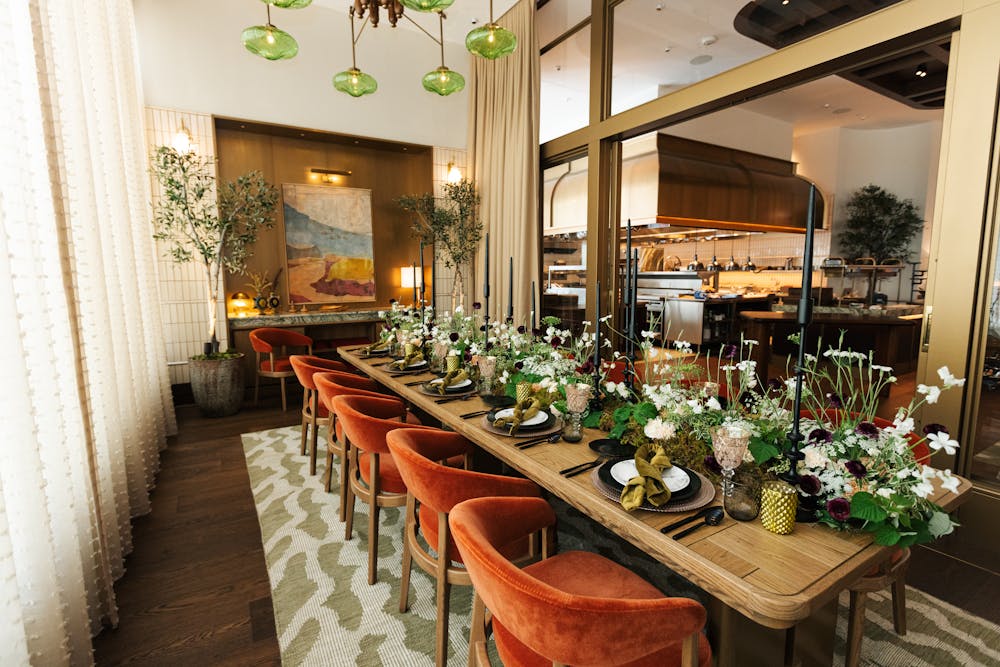 a room filled with furniture and vase of flowers on a table