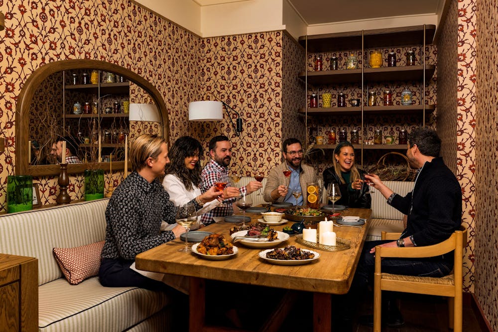 a group of people sitting at a table with wine glasses