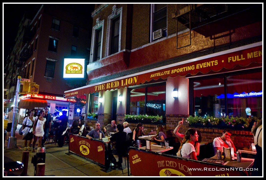 a group of people outside a bar