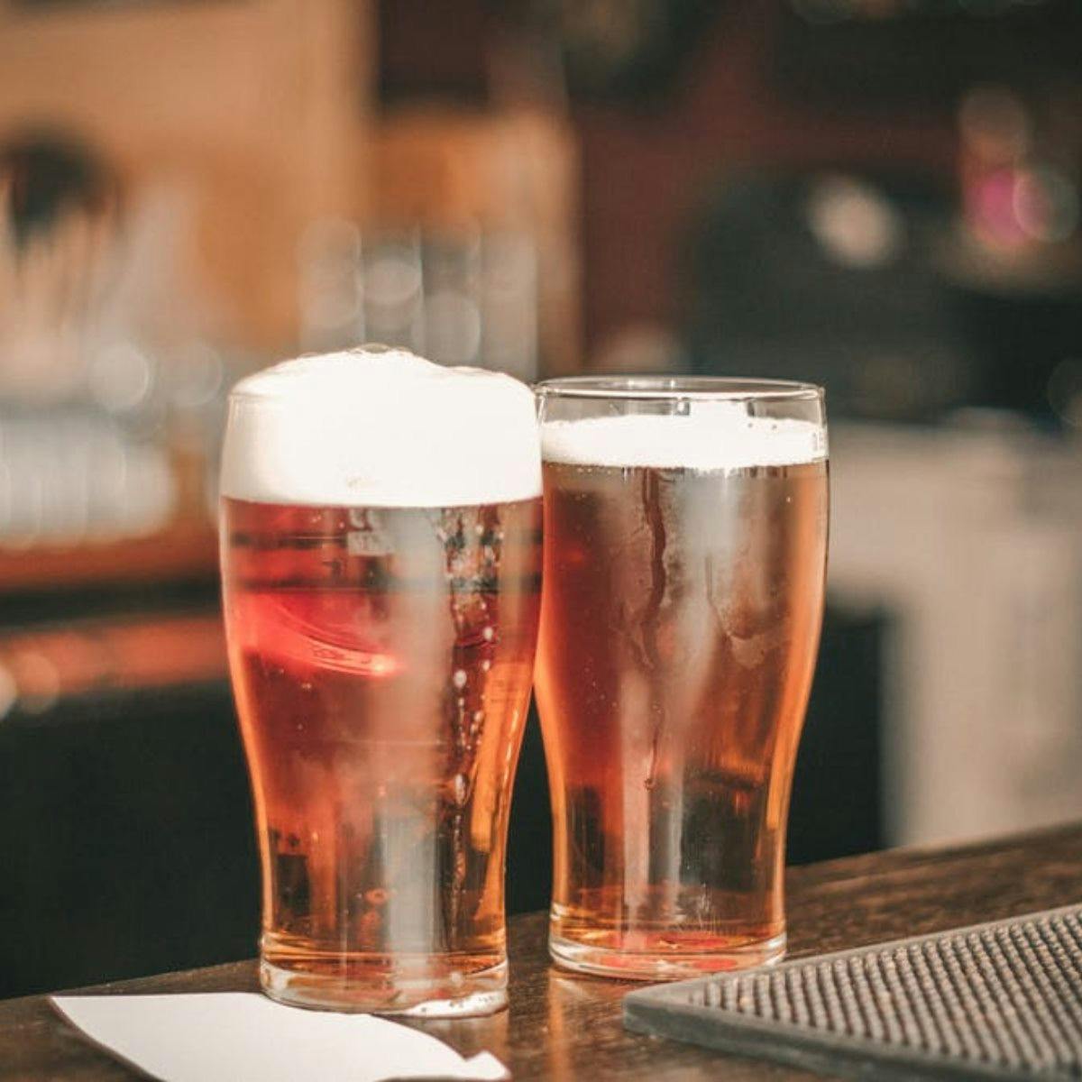a close up of a glass of beer on a table