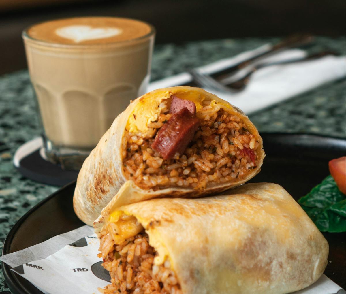 a close up of a plate of food and a cup of coffee