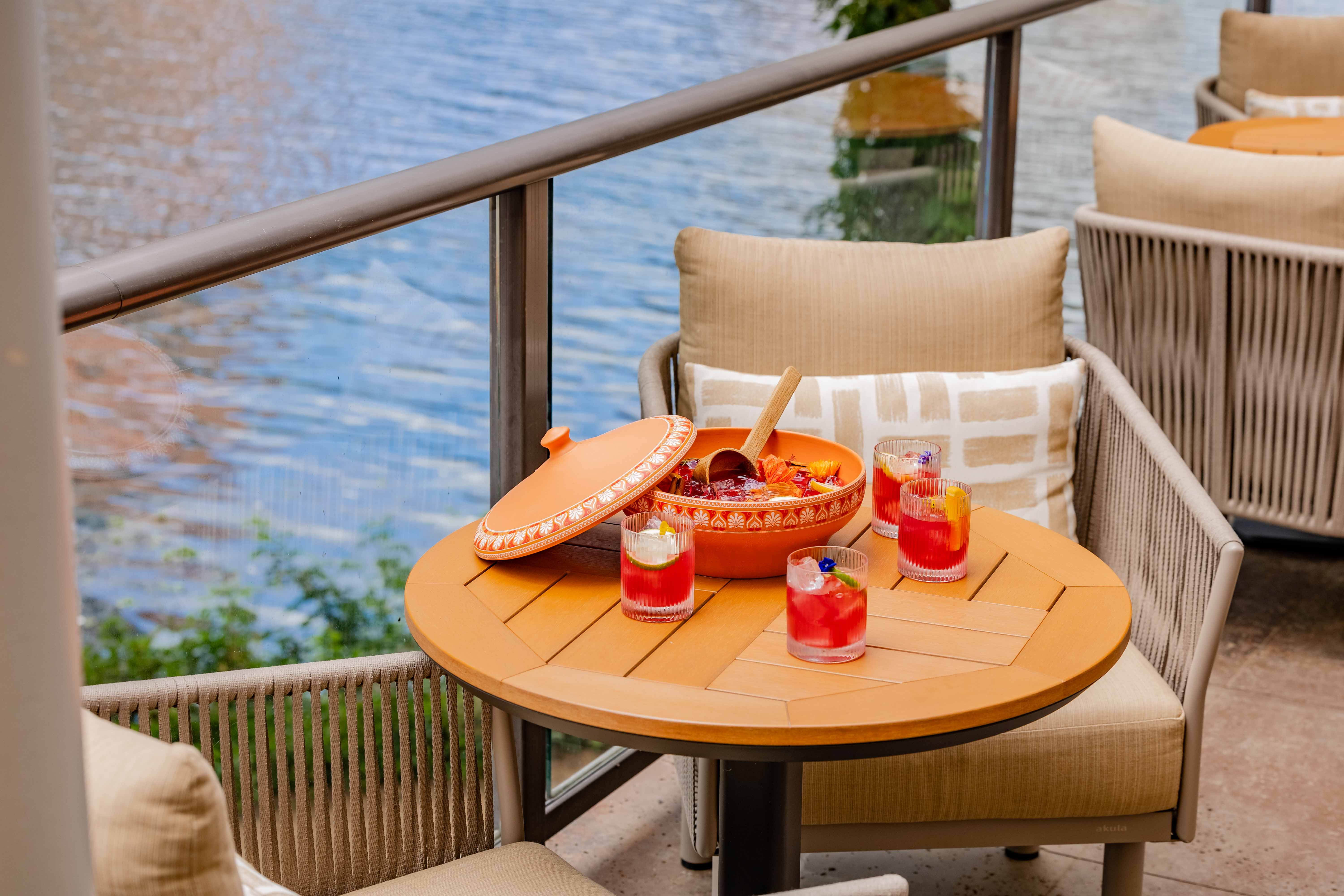 a table with drinks on it and a bowl of food on it