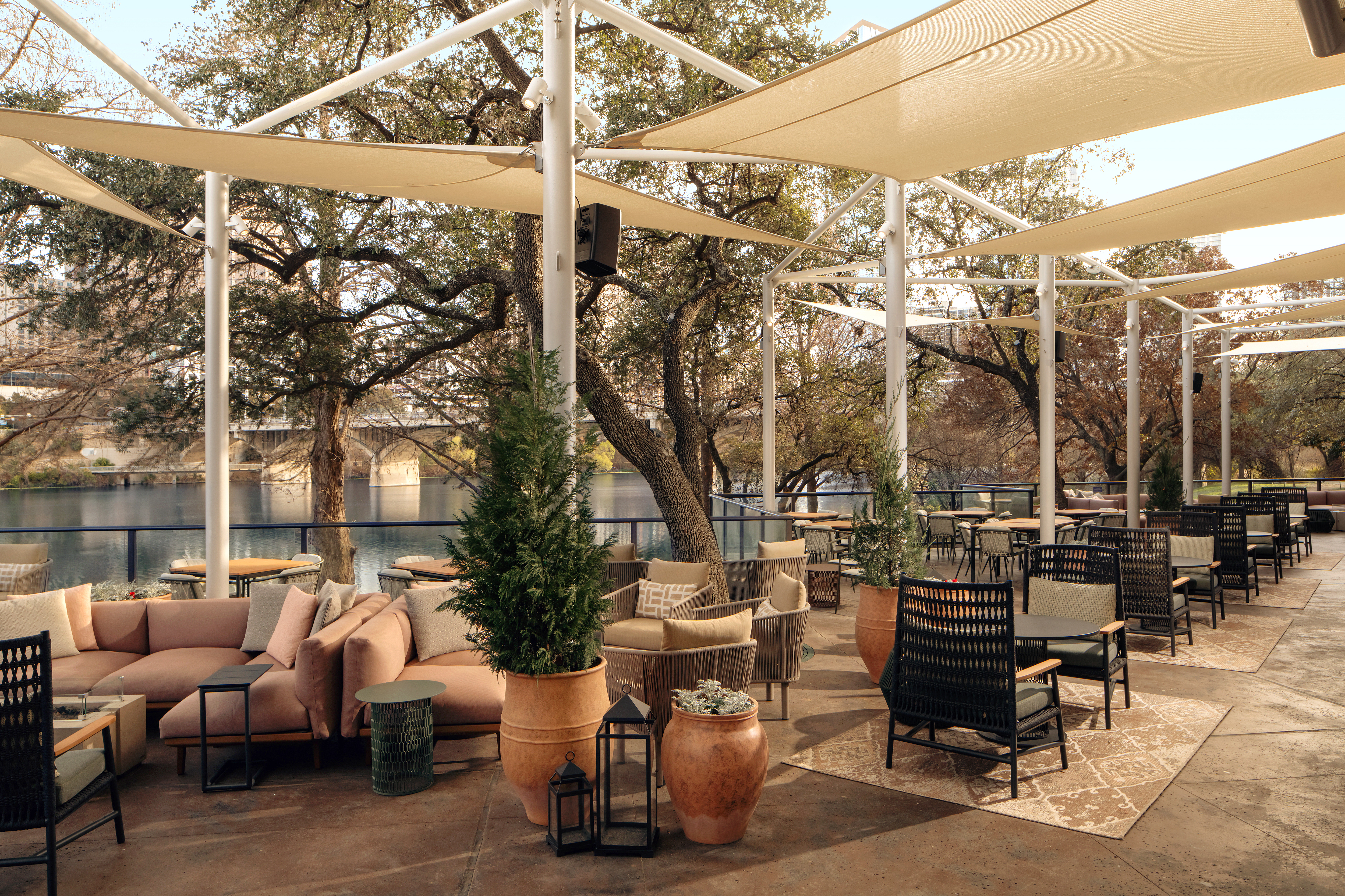 a patio with a large white canopy and tables and chairs