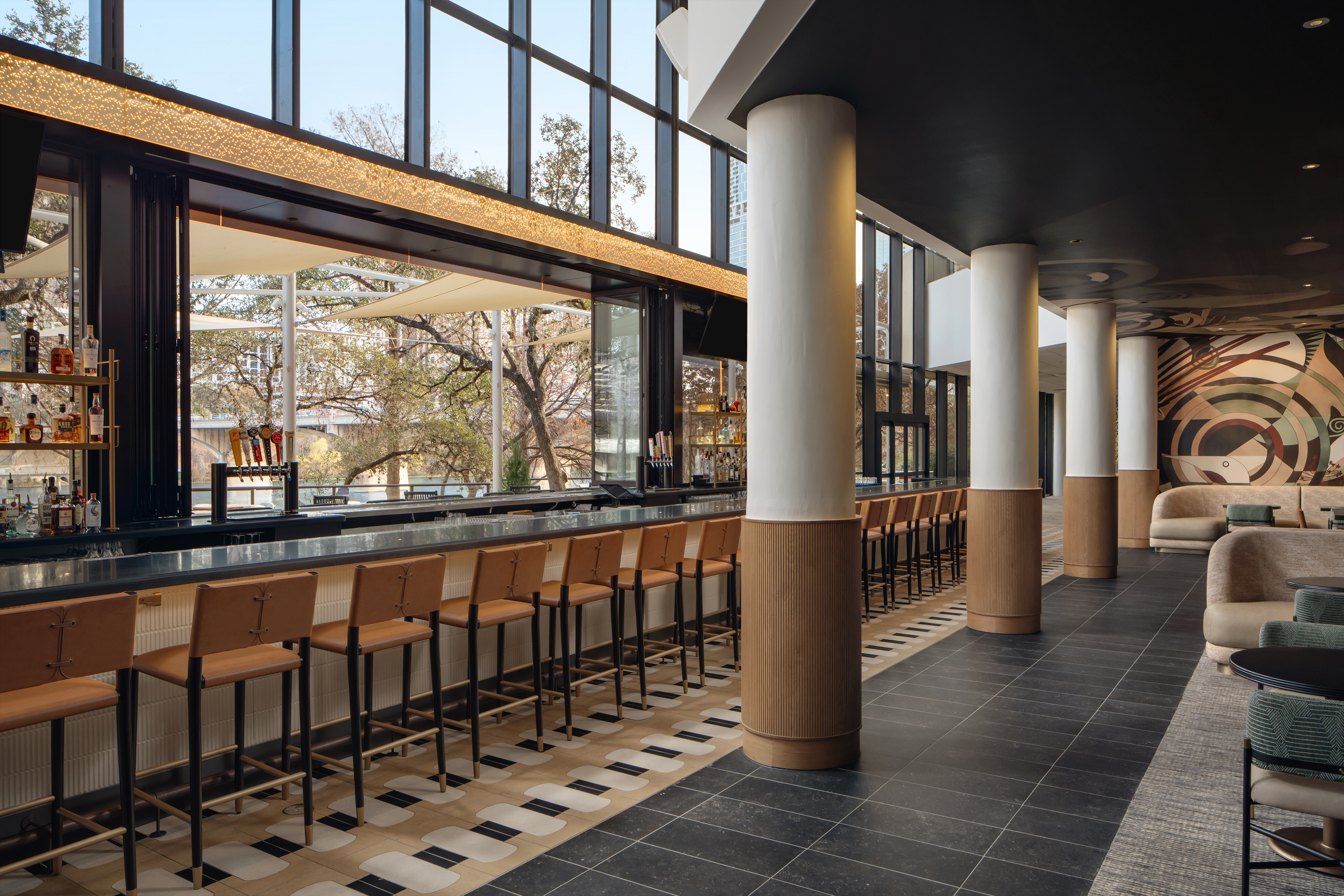 a bar with chairs in a building