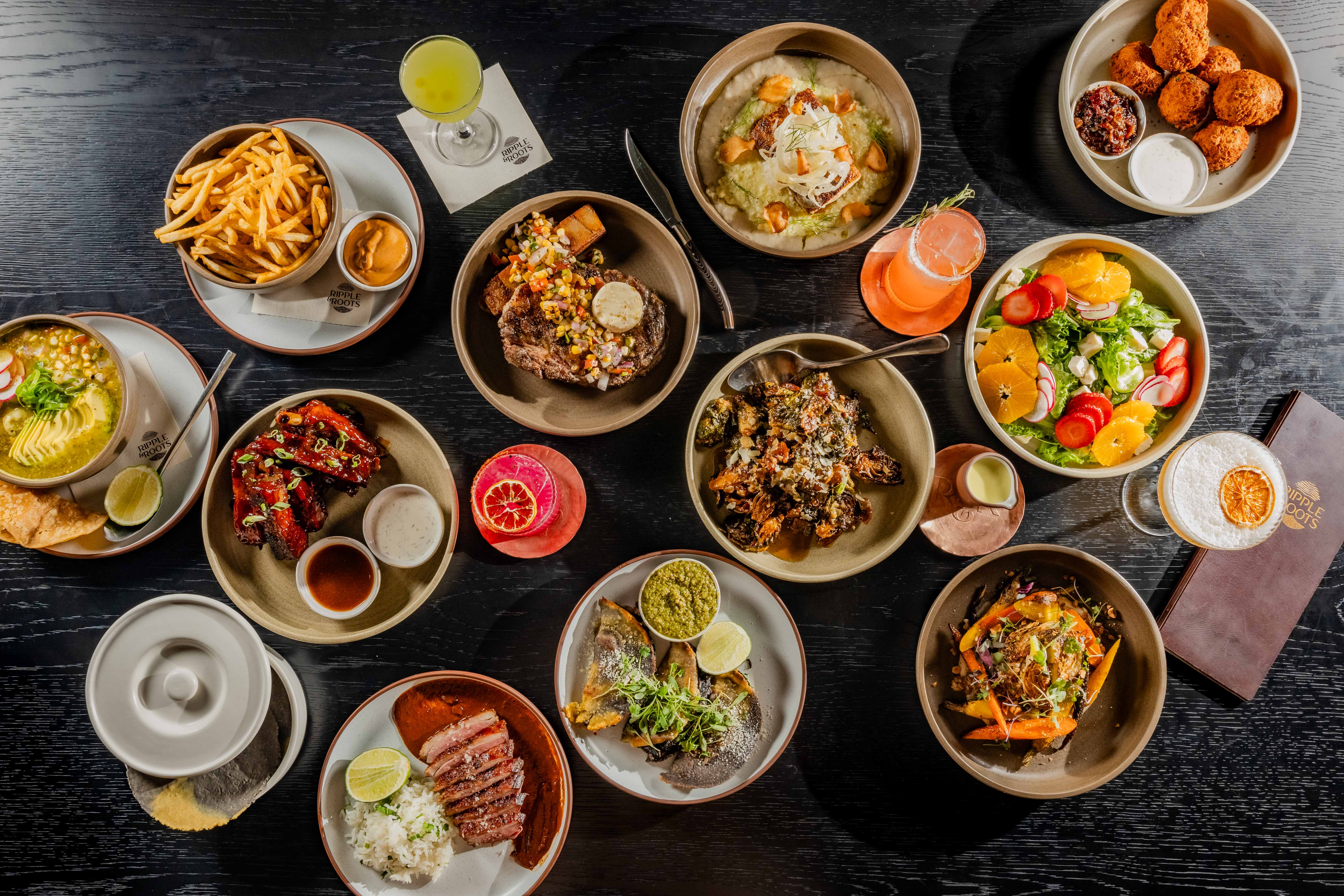 a table with plates of food and drinks
