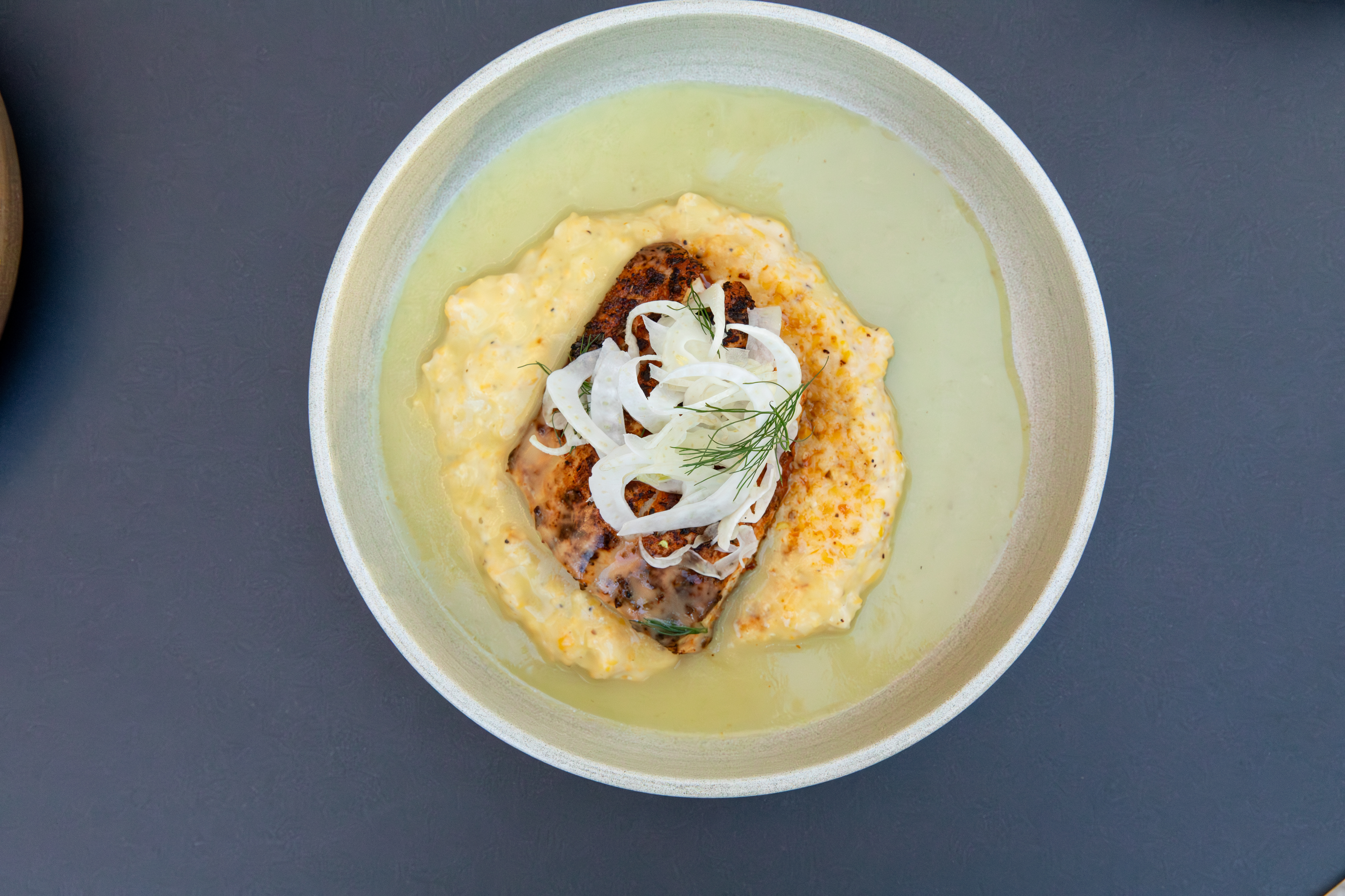 a plate of food on a gray surface