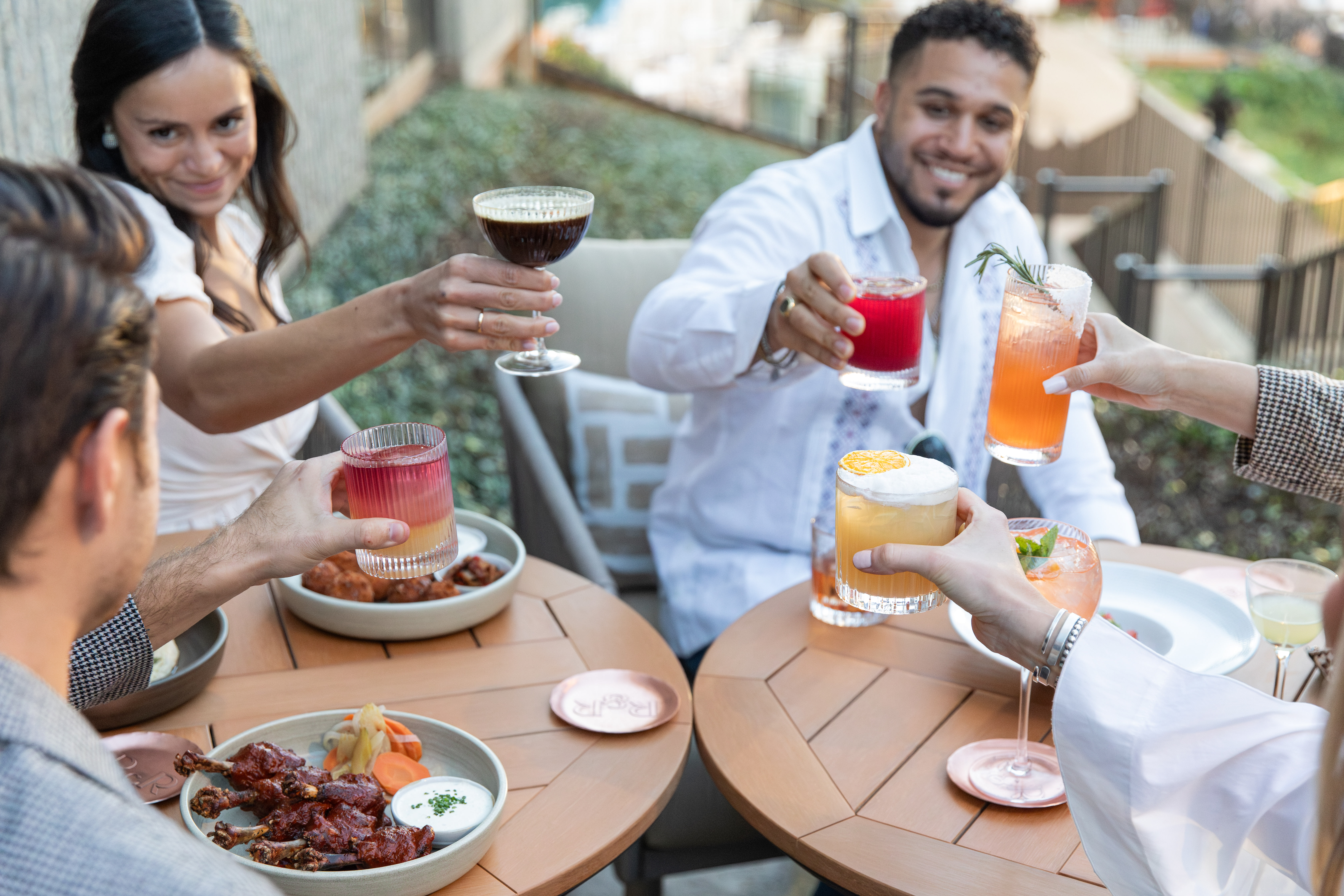 a group of people holding drinks at a table