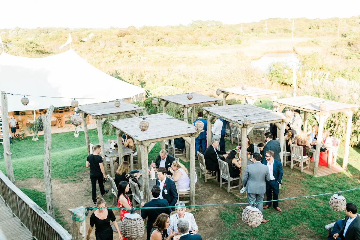 a group of people standing next to a fence
