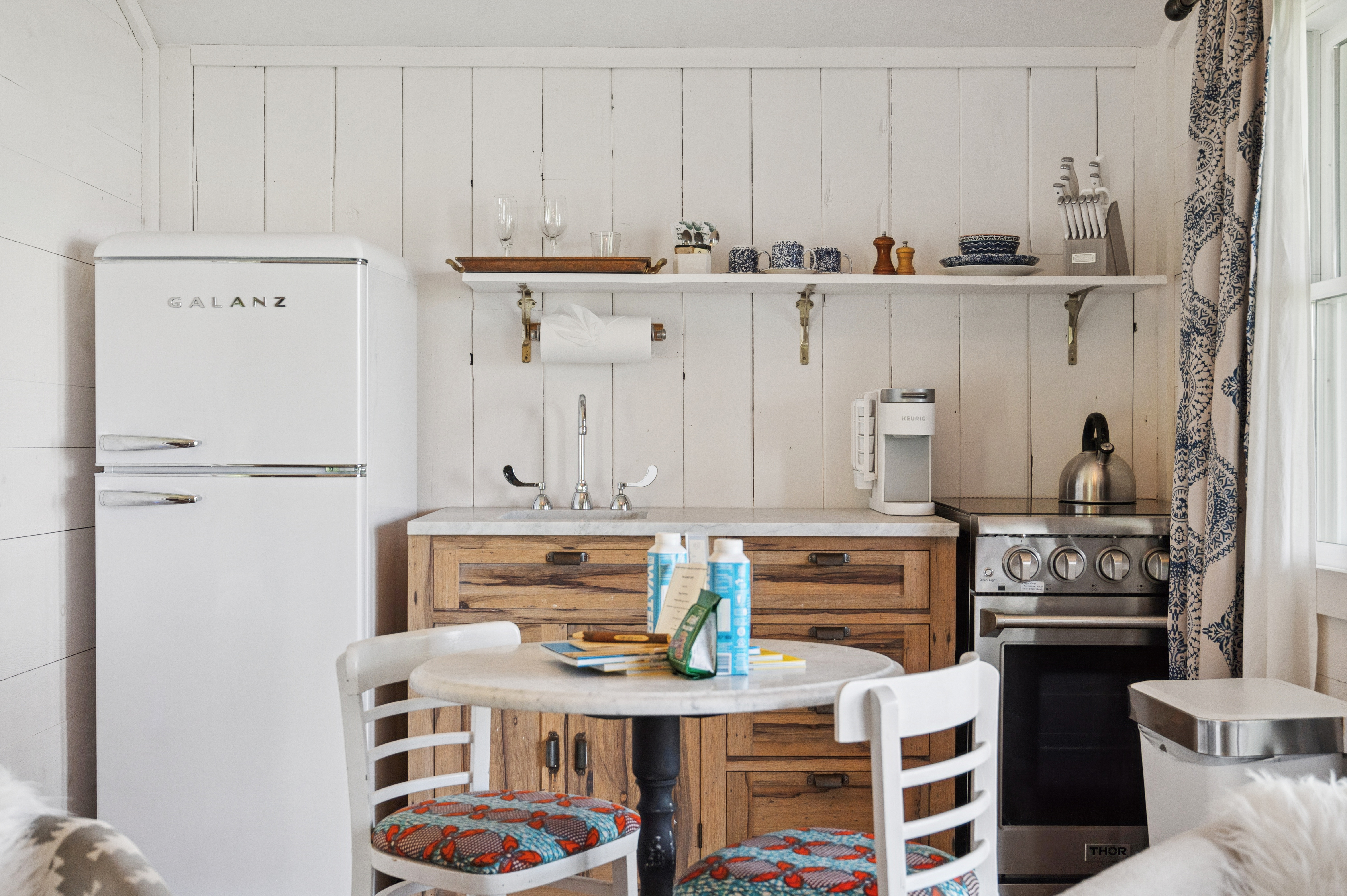 a kitchen with a table and chairs
