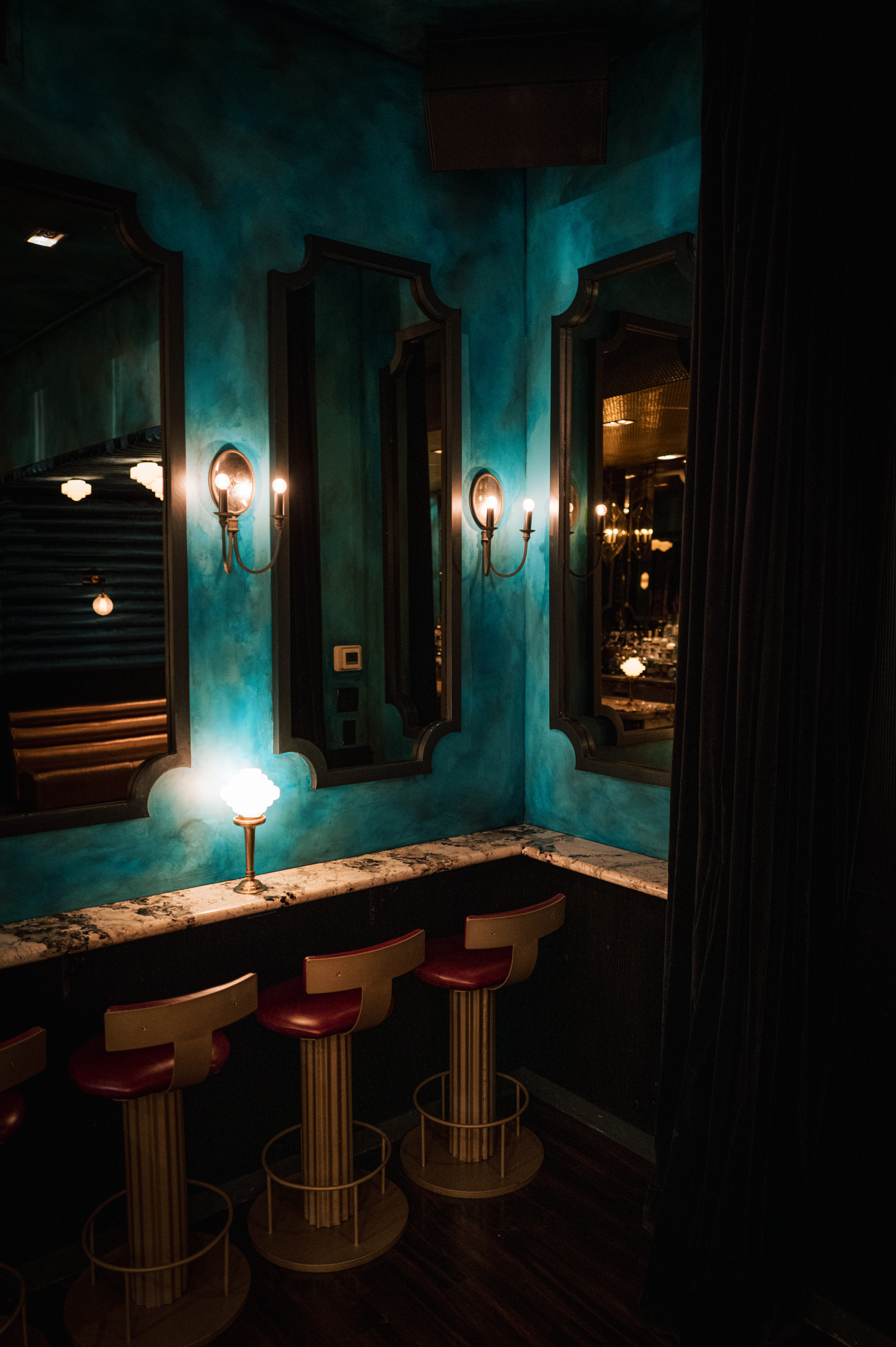 a glass with a blue light in a dark room